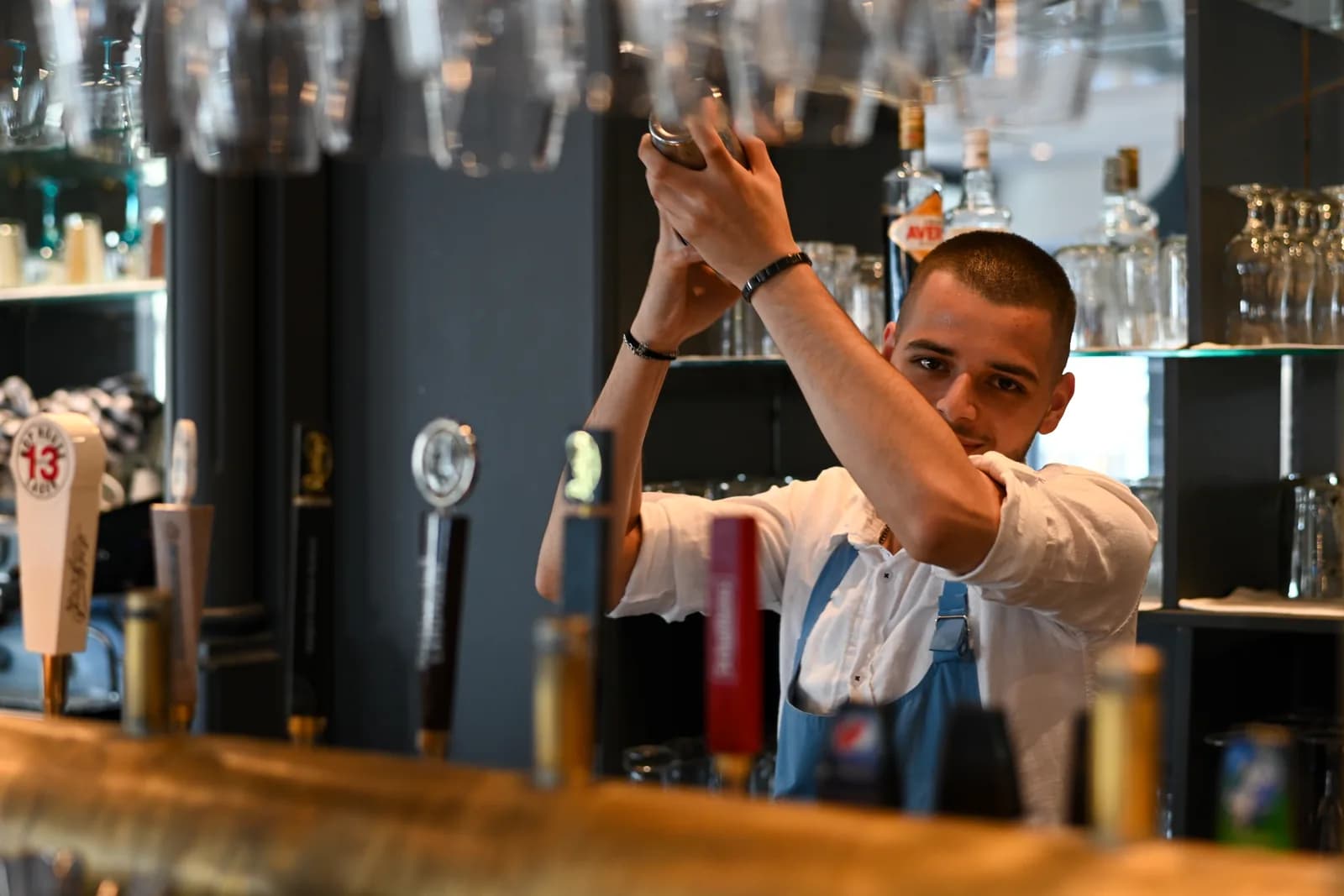 Shaking, behind the bar